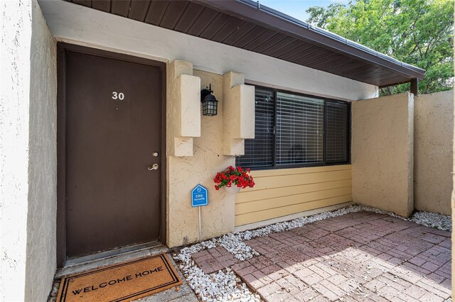 doorway to property with stucco siding