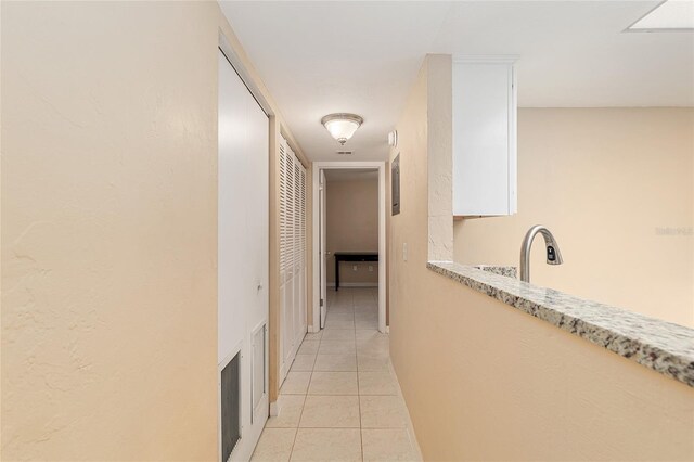 hall with light tile patterned floors