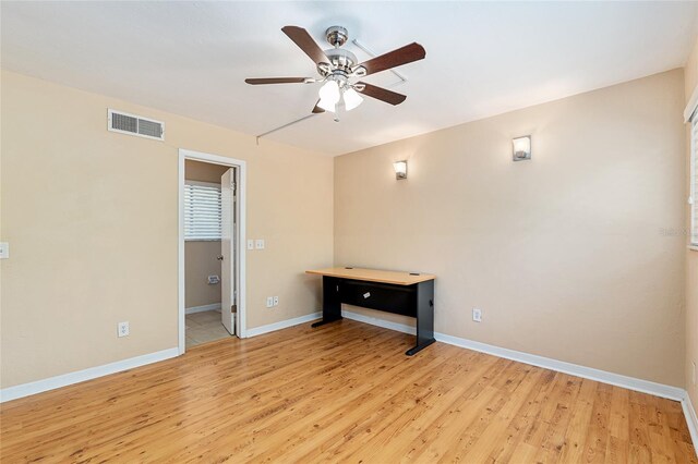 unfurnished bedroom with baseboards, visible vents, ceiling fan, and light wood-style floors