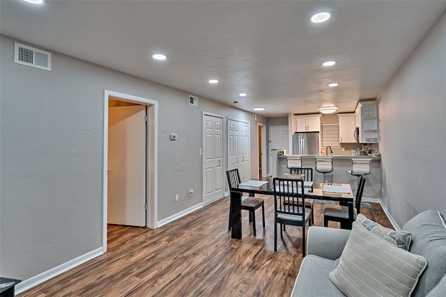 105 SE 16th Ave Unit N103, Gainesville, FL 32601 - dining space with recessed lighting and dark wood-style flooring