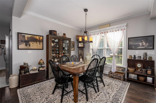 dining space with crown molding, baseboards, and dark wood finished floors
