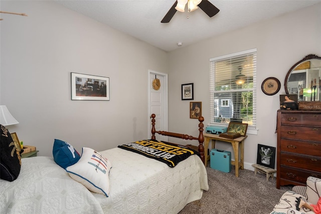 carpeted bedroom featuring baseboards and ceiling fan