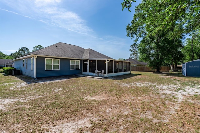 back of house with a sunroom, central AC, fence, and a yard
