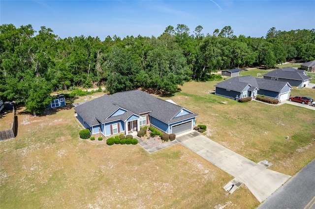 bird's eye view with a wooded view