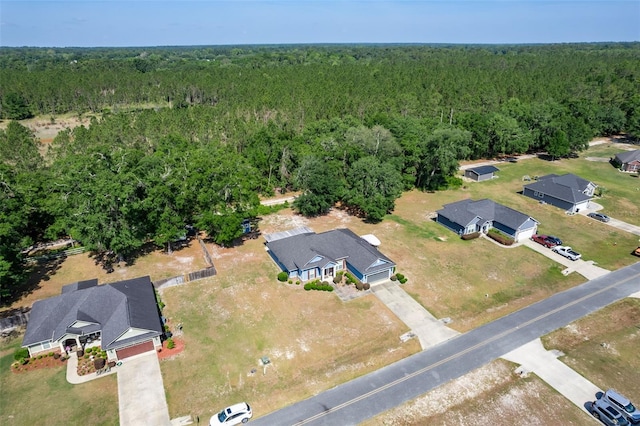 drone / aerial view featuring a view of trees