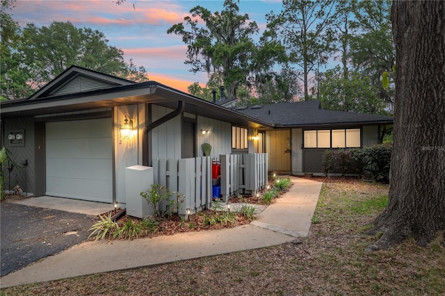 1612 NW 19th Cir, Gainesville, FL 32605 - view of front of home with an attached garage, aphalt driveway, and fence