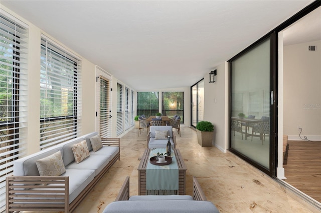 1612 NW 19th Cir, Gainesville, FL 32605 - sunroom / solarium with a wall of windows, baseboards, an outdoor hangout area, and visible vents