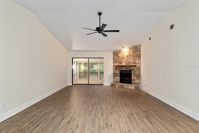 1612 NW 19th Cir, Gainesville, FL 32605 - unfurnished living room featuring a fireplace, a ceiling fan, wood finished floors, lofted ceiling, and visible vents