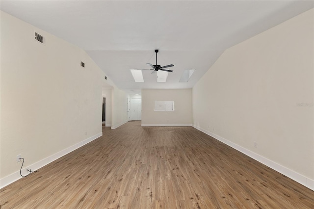 1612 NW 19th Cir, Gainesville, FL 32605 - unfurnished living room with visible vents, ceiling fan, wood finished floors, and vaulted ceiling with skylight