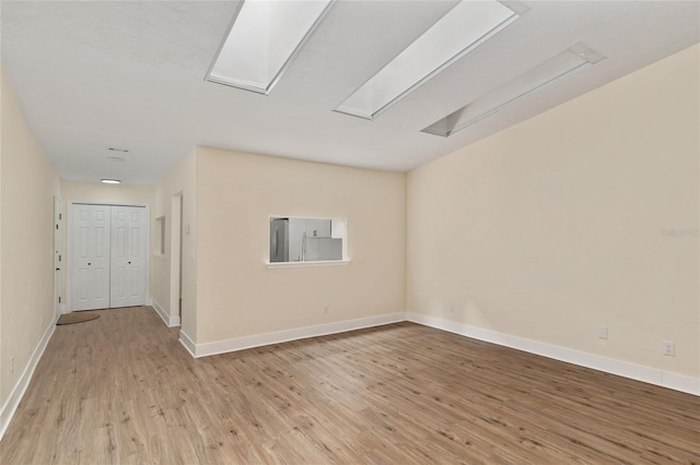 1612 NW 19th Cir, Gainesville, FL 32605 - unfurnished room featuring baseboards, attic access, and wood finished floors