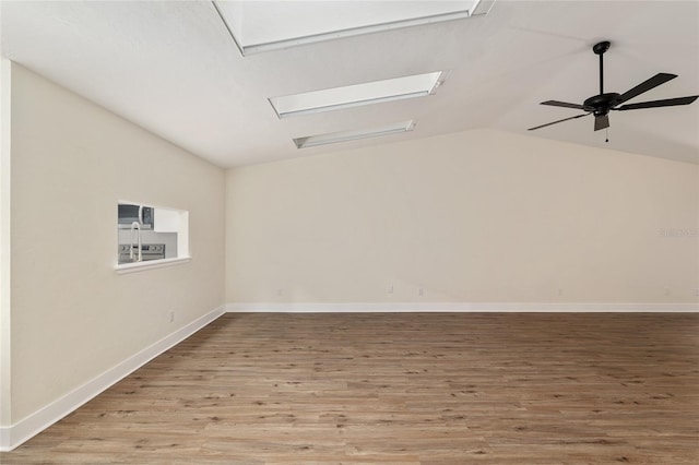 1612 NW 19th Cir, Gainesville, FL 32605 - unfurnished room featuring baseboards, ceiling fan, wood finished floors, and lofted ceiling
