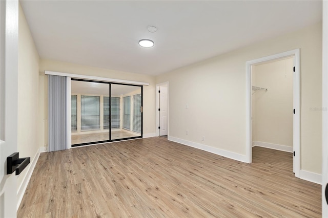 1612 NW 19th Cir, Gainesville, FL 32605 - empty room with baseboards and light wood-type flooring