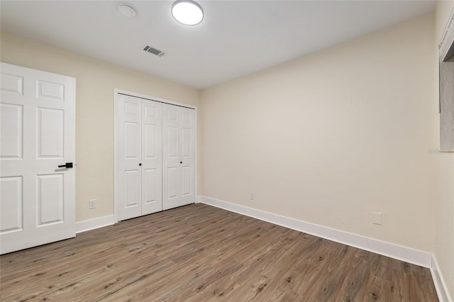 1612 NW 19th Cir, Gainesville, FL 32605 - unfurnished bedroom featuring baseboards, visible vents, and wood finished floors