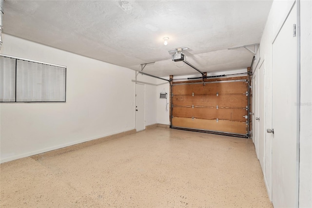 1612 NW 19th Cir, Gainesville, FL 32605 - garage featuring baseboards and a garage door opener