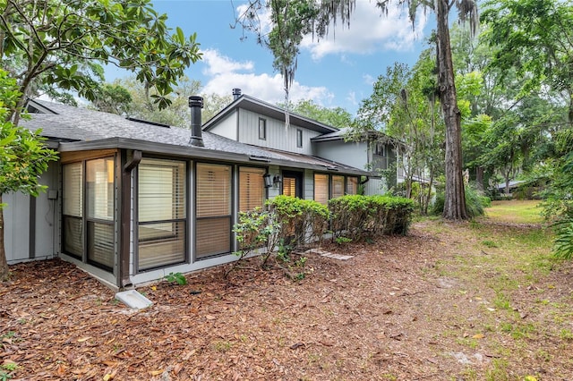 1612 NW 19th Cir, Gainesville, FL 32605 - rear view of property featuring a sunroom and a shingled roof