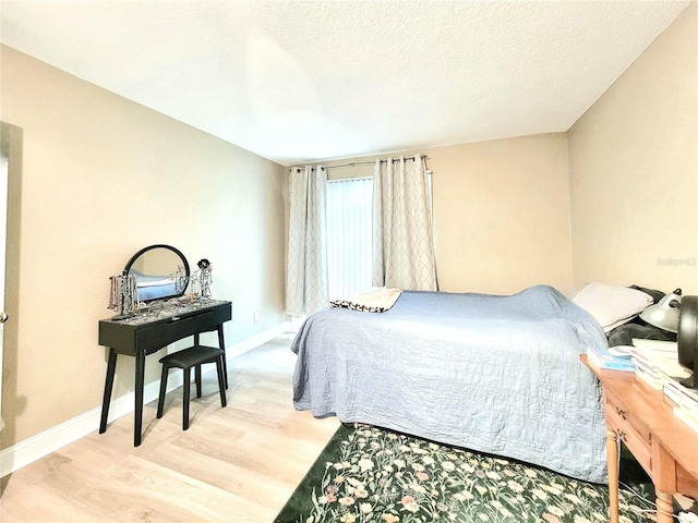 bedroom featuring light wood-type flooring and baseboards