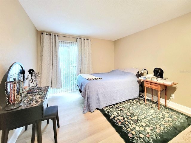 bedroom with wood finished floors and baseboards