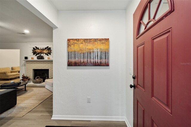 4511 SW 83rd Dr, Gainesville, FL 32608 - foyer entrance with light wood-style floors, baseboards, a fireplace, and recessed lighting