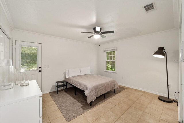 4511 SW 83rd Dr, Gainesville, FL 32608 - bedroom with crown molding, light tile patterned floors, baseboards, and ceiling fan