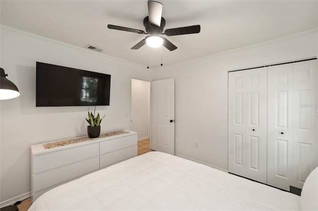 4511 SW 83rd Dr, Gainesville, FL 32608 - bedroom featuring crown molding, a closet, ceiling fan, and baseboards