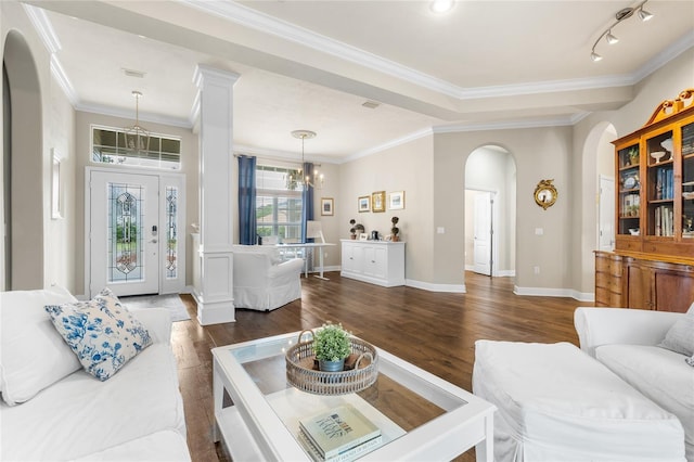 living area featuring arched walkways, ornamental molding, dark wood finished floors, and a notable chandelier