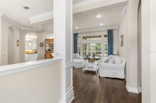 hall featuring crown molding, visible vents, dark wood-style flooring, recessed lighting, and arched walkways