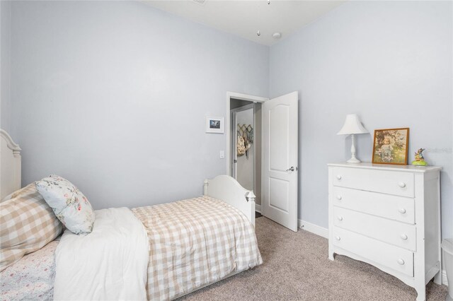 bedroom featuring light colored carpet