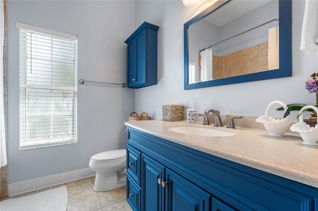bathroom featuring vanity, toilet, tile patterned floors, baseboards, and a shower with curtain