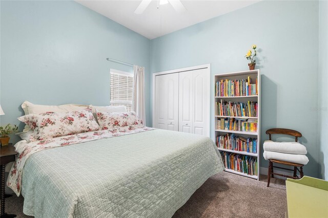 carpeted bedroom featuring a closet and ceiling fan