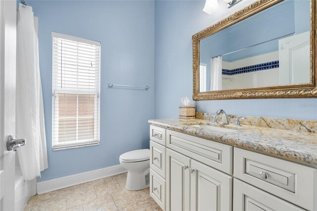 bathroom featuring vanity, toilet, tile patterned floors, baseboards, and curtained shower