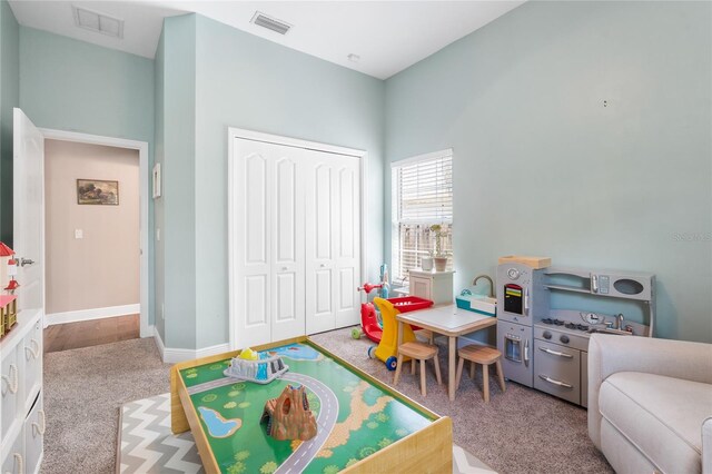 rec room with carpet floors and visible vents