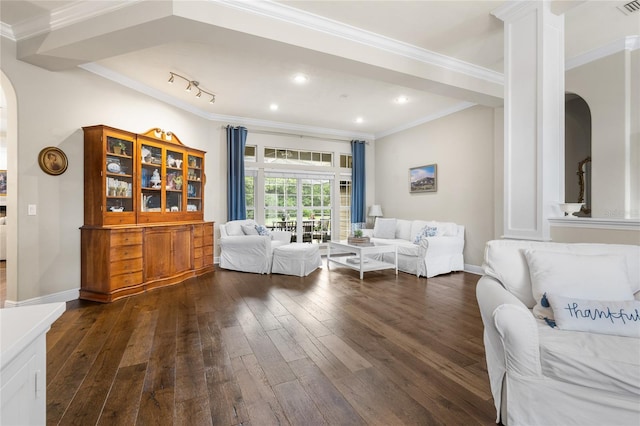 living room with arched walkways, ornamental molding, and dark wood finished floors