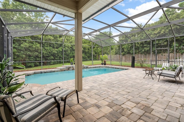view of swimming pool featuring a patio, a fenced backyard, glass enclosure, and a fenced in pool
