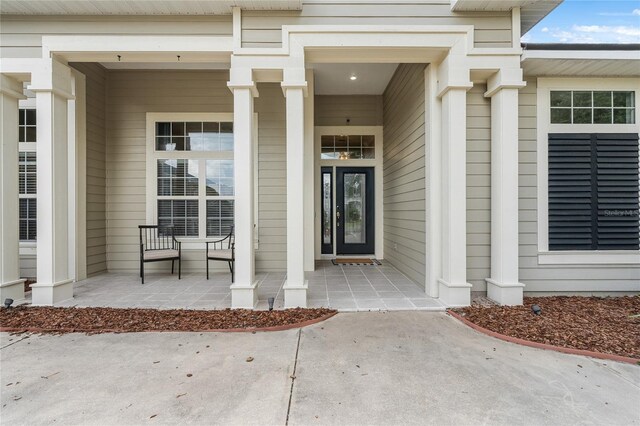 view of exterior entry featuring a porch