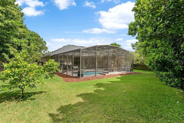 view of yard featuring fence and an outdoor pool