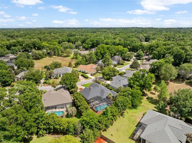 bird's eye view featuring a residential view and a forest view