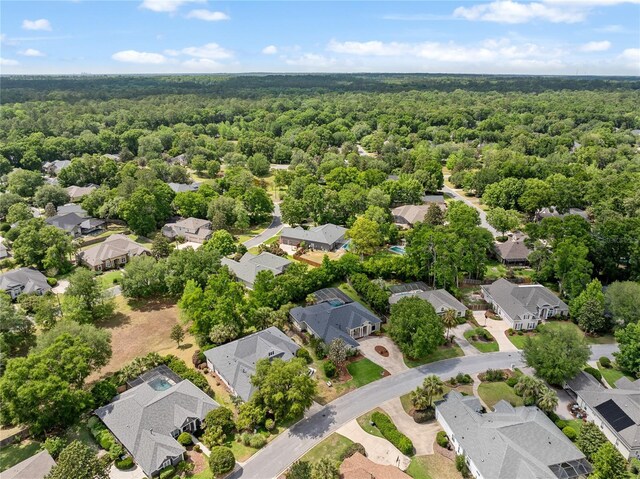 birds eye view of property with a residential view and a wooded view