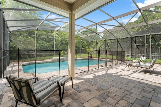 view of pool with a patio, a fenced backyard, glass enclosure, and a fenced in pool