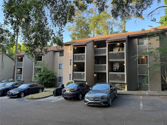 view of building exterior featuring uncovered parking