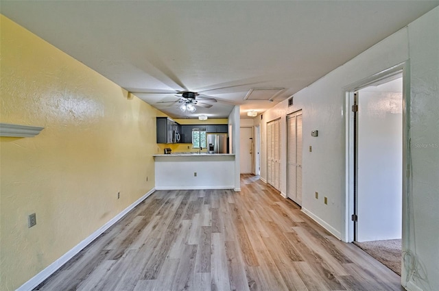 111 SE 16th Ave Unit O304, Gainesville, FL 32601 - unfurnished living room with light wood finished floors, a textured wall, and ceiling fan