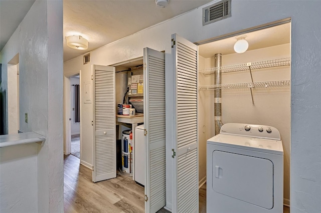 111 SE 16th Ave Unit O304, Gainesville, FL 32601 - laundry area featuring washer / dryer and light wood-style floors
