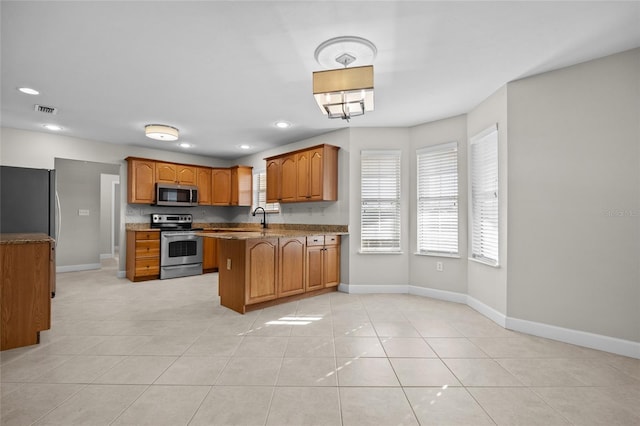 kitchen with visible vents, brown cabinets, a wealth of natural light, and stainless steel appliances
