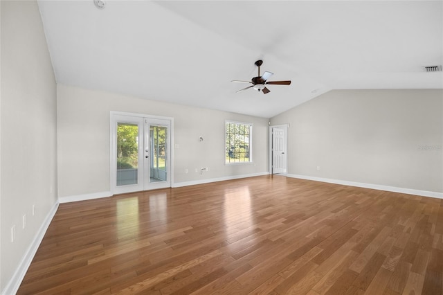 unfurnished living room featuring visible vents, wood finished floors, baseboards, a ceiling fan, and vaulted ceiling