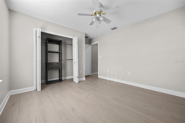 unfurnished bedroom featuring baseboards, ceiling fan, light wood finished floors, and visible vents
