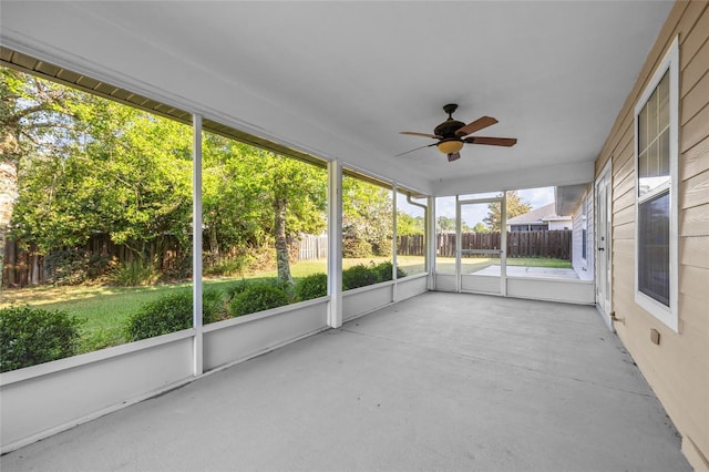 unfurnished sunroom featuring a ceiling fan