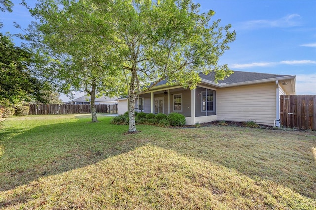 back of house with a lawn and a fenced backyard