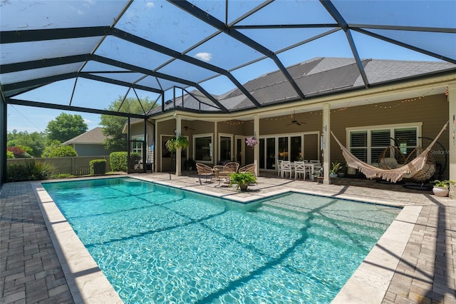 view of swimming pool featuring fence, a patio, a fenced in pool, a ceiling fan, and a lanai