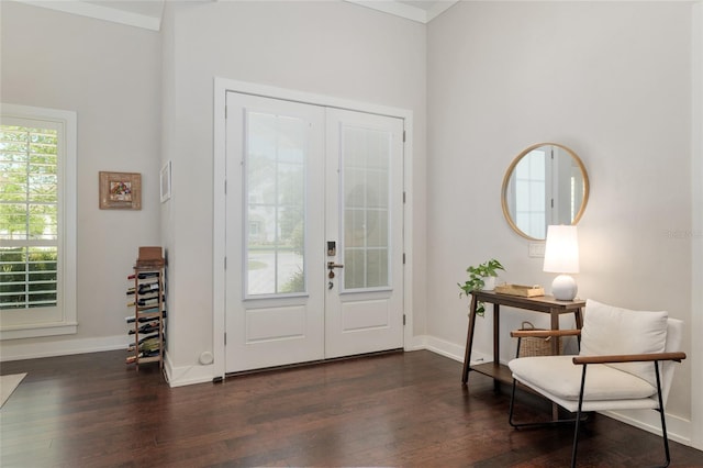 foyer entrance with french doors, dark wood-style flooring, and baseboards