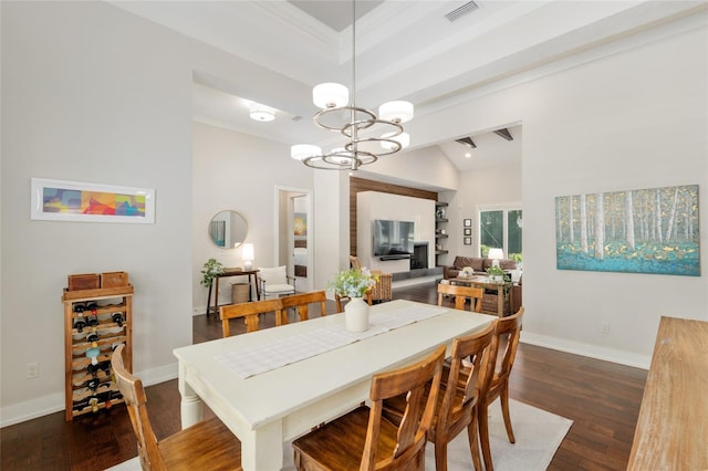 dining area with visible vents, baseboards, dark wood-style flooring, and lofted ceiling