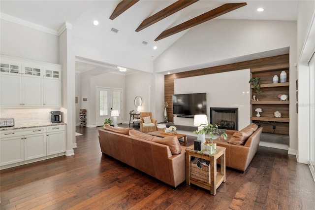 living area featuring visible vents, crown molding, dark wood-style flooring, beam ceiling, and a fireplace